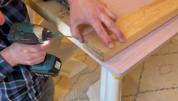 Attach the bottom ledge, using screws for sturdiness.