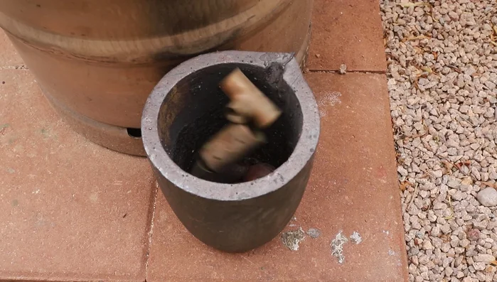Pour molten copper into the molds quickly and carefully.
