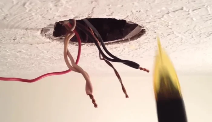 Use a voltage detector to check that the wires are not live before handling.