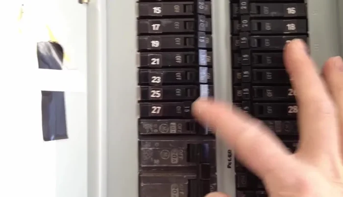 Use blue tape to secure the old fixture to the ceiling while lowering it.