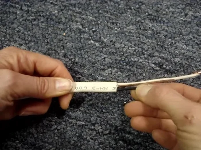 Create a taper on the NM cable end to prevent catching during pulling.