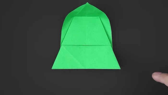 Unfold. Separate the inner layer, bring one part behind the other, align, and reinforce. Repeat on the other side.