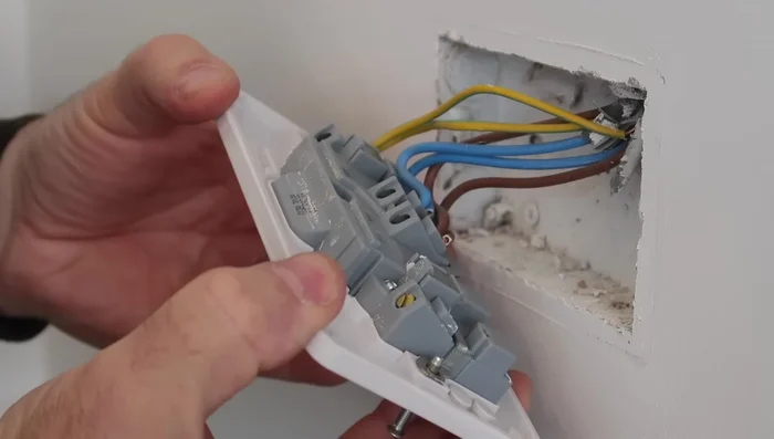 Remove the existing socket and tape up the wires to prevent accidental contact.