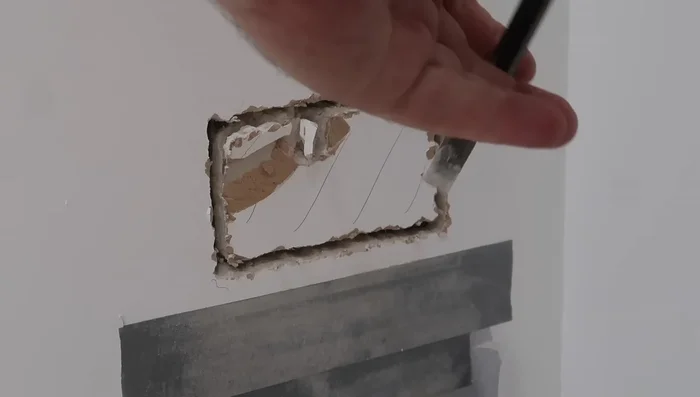 Use a chisel to carefully remove excess brick material around the hole to create a recess for the back box.