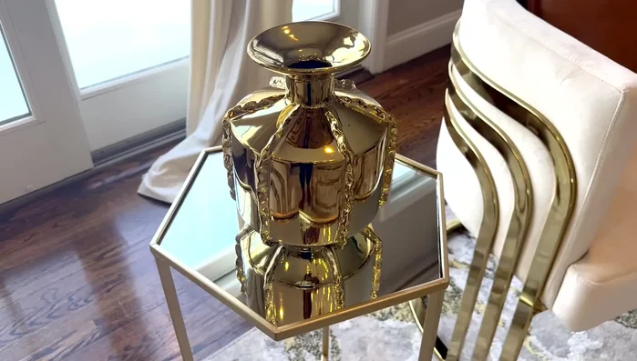 Decorate the coffee table with a bouquet of flowers, candles, a tray, coasters, and other decorative items.