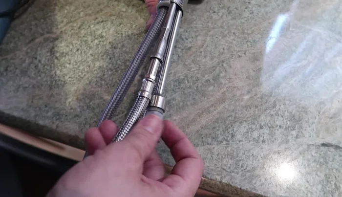 Secure the faucet with the nut, washer, and gasket. Tighten the screws on the nut evenly.