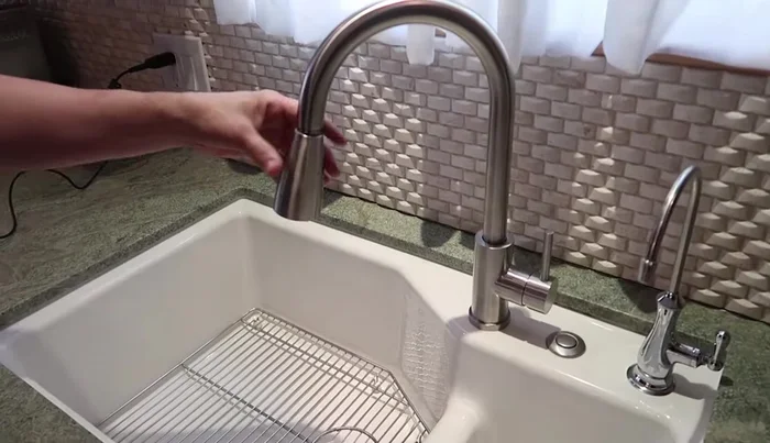 Connect the hot and cold water lines to the angle stops using brass adapters if necessary.