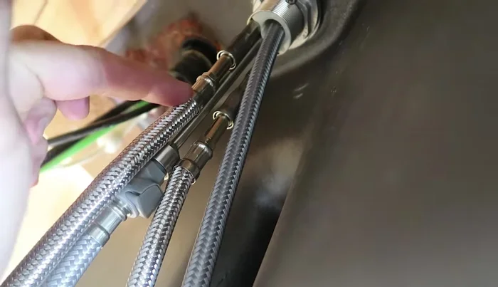 Connect the hot and cold water lines to the angle stops using brass adapters if necessary.