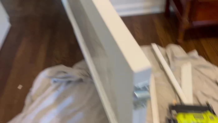 Install the new door into the pocket, starting with the wheel closest to the pocket.