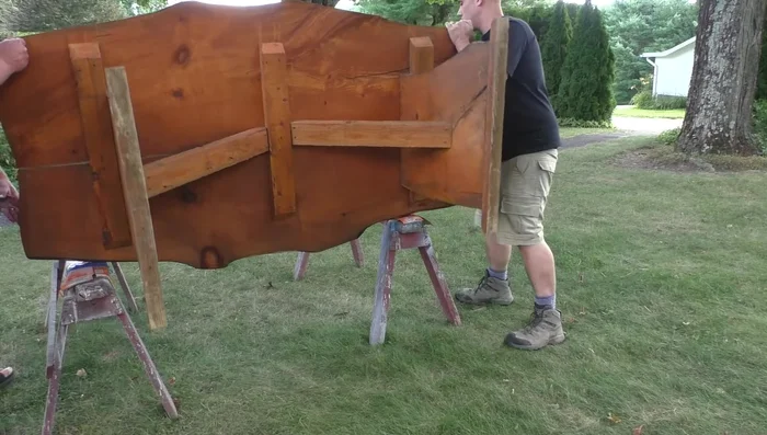 Flip the table over to access the underside.