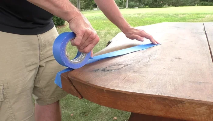 Seal the crack with blue tape, paying close attention to prevent epoxy leakage.