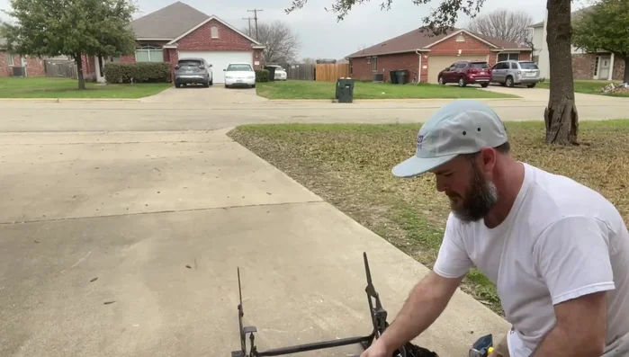 Straighten the bent metal using a hammer, striking from both sides. An F-style clamp can assist.