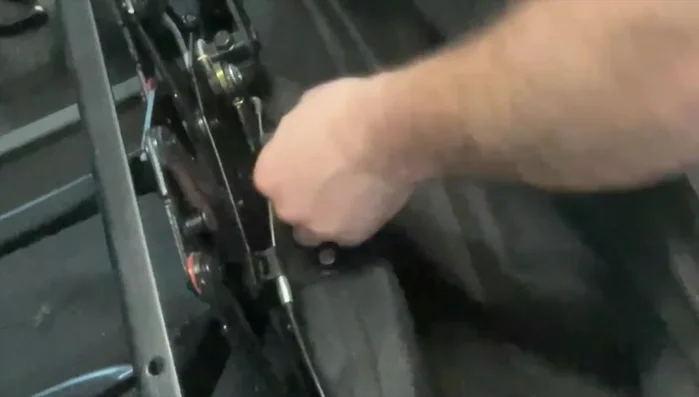 Secure the mechanism to the center console with wood screws.