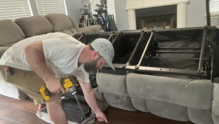 Remove screws (typically 3-4 Phillips head screws on each side) securing the mechanism.