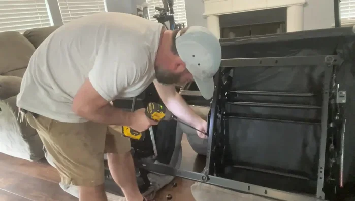 Remove screws (typically 3-4 Phillips head screws on each side) securing the mechanism.