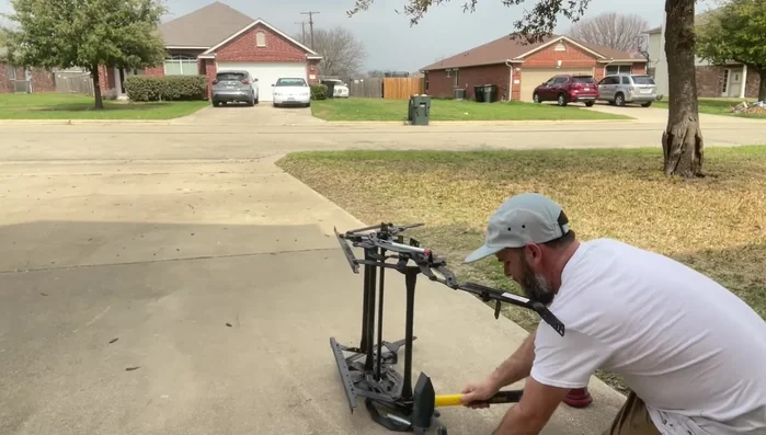 Straighten the bent metal using a hammer, striking from both sides. An F-style clamp can assist.