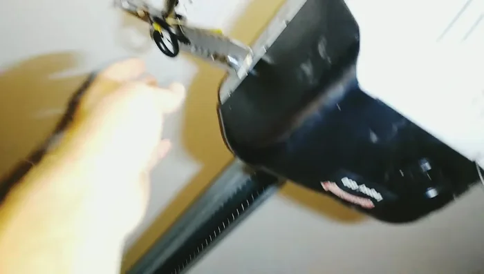 Secure the garage door using dowel rods and clamps to prevent it from dropping.