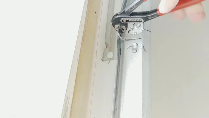 Straighten any remaining bent sections of the track using alligator pliers.