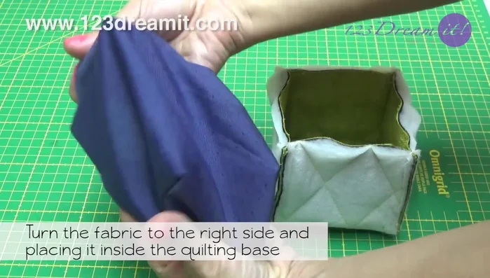Turn the cotton fabric right side out and place it inside the quilted base. Secure with safety pins and sew, leaving a stitch slit.