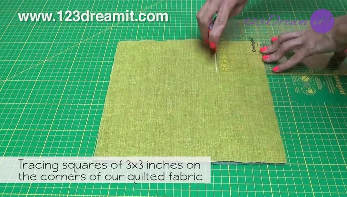 Trace 3x3 inch squares on the corners of the quilted fabric and cut them out.