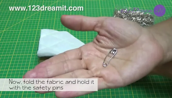 Remove safety pins, open the fabric, and sew the edges to create the basket shape. Secure with safety pins and sew again to form the base.