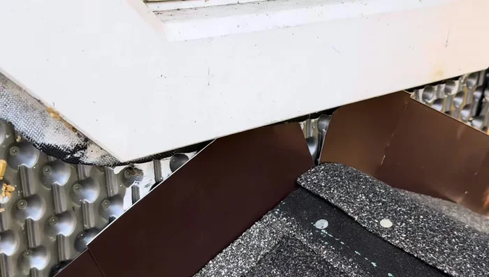 Install building wrap and siding over the flashing to complete the waterproofing.