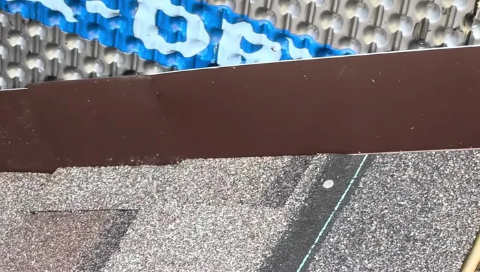 Install the shingle over the step flashing, securing with roofing nails. Position step flashing to minimize visibility.