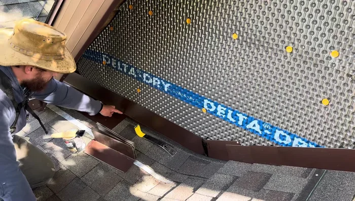 Apply the final layer of shingles over the flashing, securing only with roofing caulk (not nails).