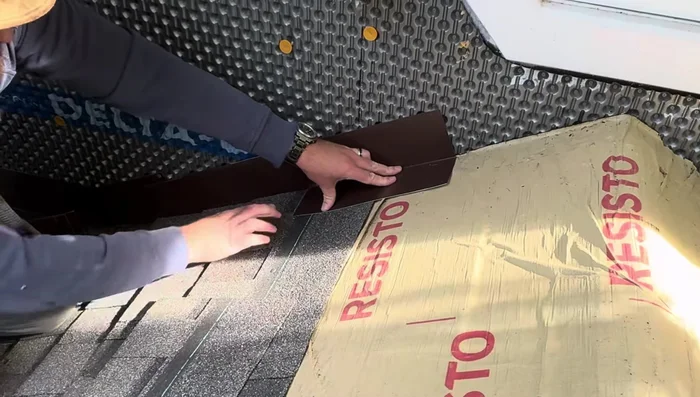 Install the shingle over the step flashing, securing with roofing nails. Position step flashing to minimize visibility.