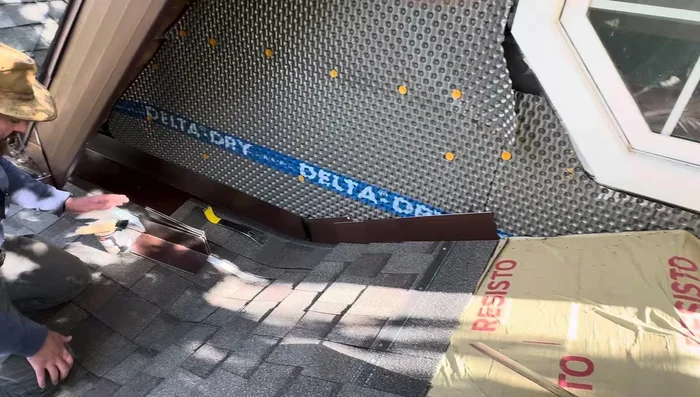 Apply the final layer of shingles over the flashing, securing only with roofing caulk (not nails).