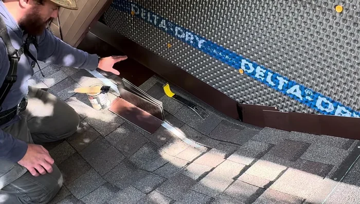 Apply the final layer of shingles over the flashing, securing only with roofing caulk (not nails).