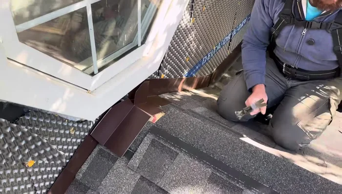 Install the final shingles over the peak flashing.