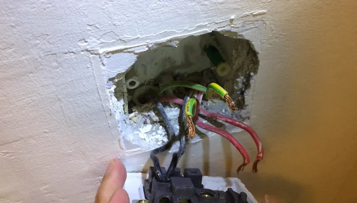 Carefully remove the old wall socket, noting the wire connections.