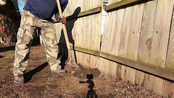 Remove any obstructions, such as tree roots, that might interfere with the new post's placement.