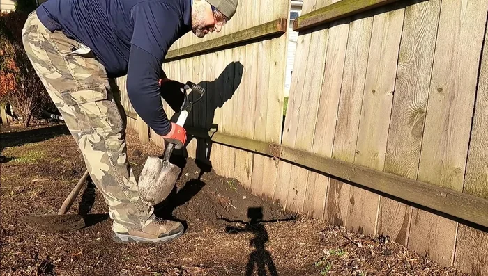 Remove any obstructions, such as tree roots, that might interfere with the new post's placement.