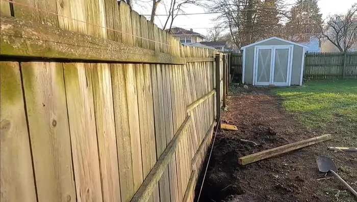 Set up a string line to ensure the new post is aligned with the rest of the fence.
