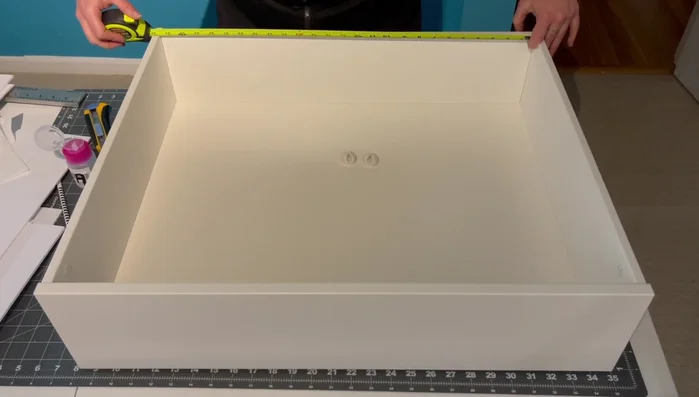 Attach cord clips to the middle of the back of the drawer, ensuring vertical alignment using a speed square.