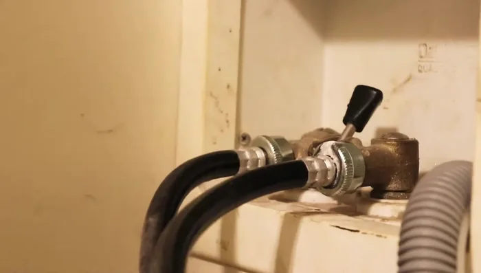 Remove the old hoses from the back of the washing machine. Be prepared for some water leakage.