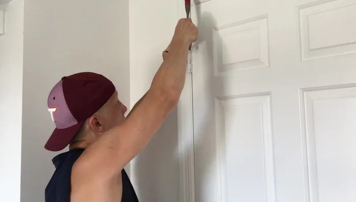 Once the pin is mostly out, use the claw end of the hammer to remove it completely.