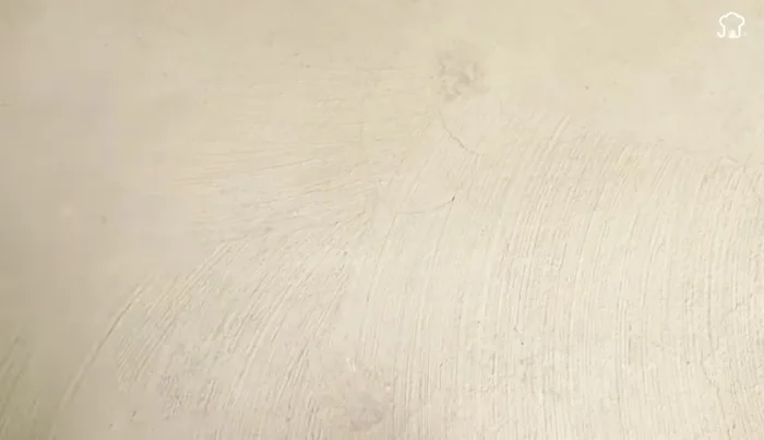 Attach the metal hook: Thread the metal hook through the bottom of the larger bottle