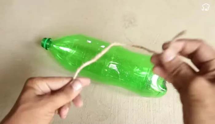 Finishing touches: Fill the larger bottle with water and attach the cap assembly