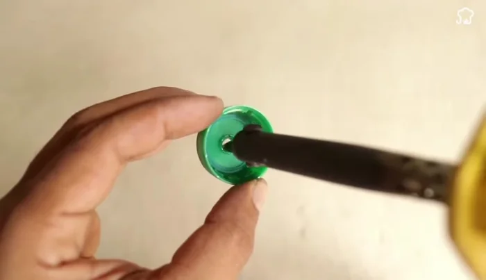 Prepare the rubber piece: Make a hole in the center of a circular rubber piece (using a soldering iron)