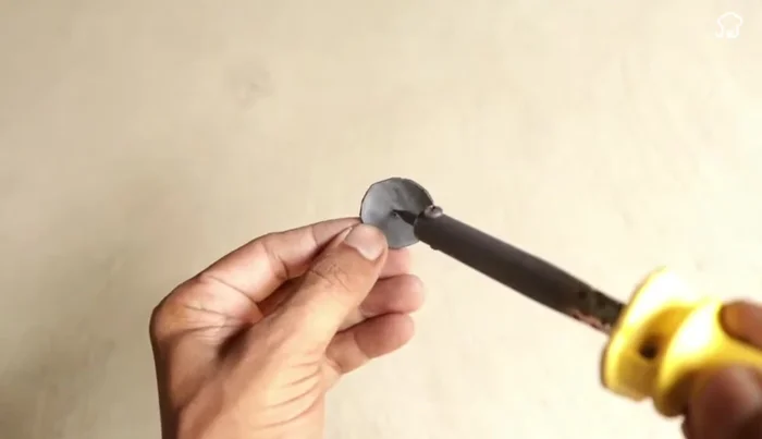 Prepare the rubber piece: Make a hole in the center of a circular rubber piece (using a soldering iron)
