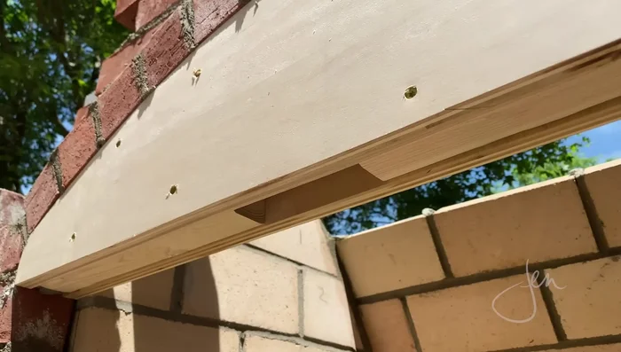 Create the arched opening: Use a plywood and 2x4 template for accurate brick cutting and placement.