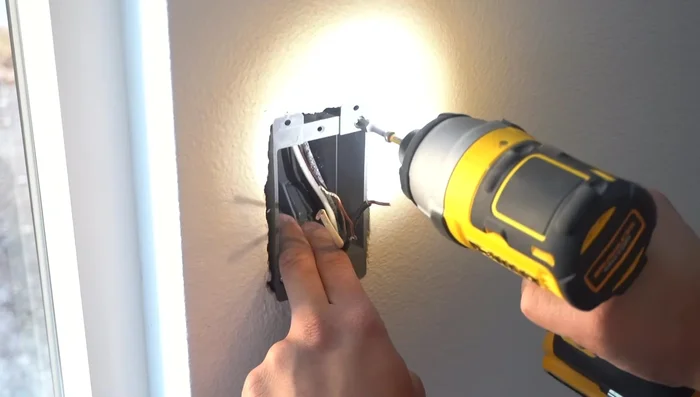 Insert the new outlet into the J-box and secure it.