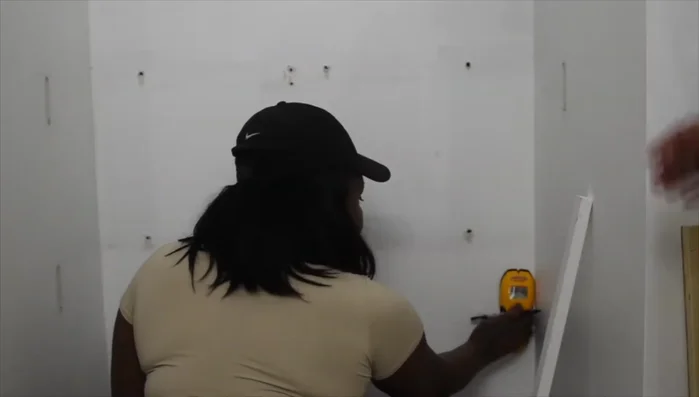 Locate studs in the wall using a stud finder.
