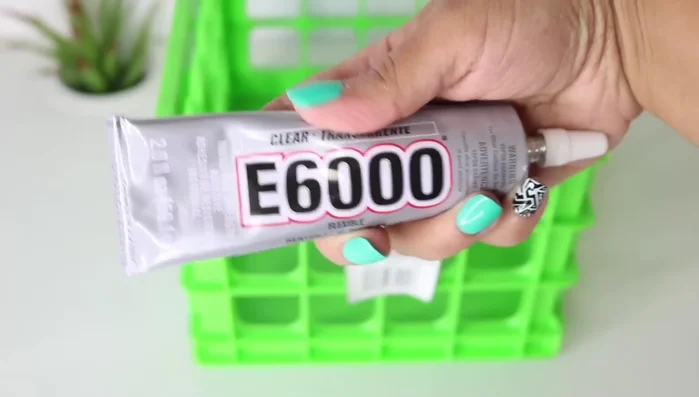 Attach frame to crate: Apply baby oil to prevent glue seepage. Add more E6000 to the frame's edge, position it on the crate, ensuring alignment of all sides.