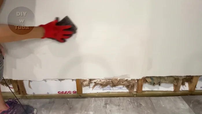 Sand the skim coat for a final, smooth finish.