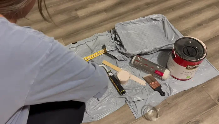 Creating scallop detail on accent wall using a lid as a template and hand-painting with an eyeshadow brush