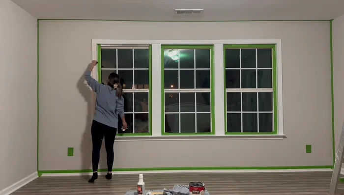 Creating scallop detail on accent wall using a lid as a template and hand-painting with an eyeshadow brush